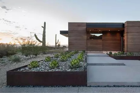 succulents and large stones in weathering steel planters